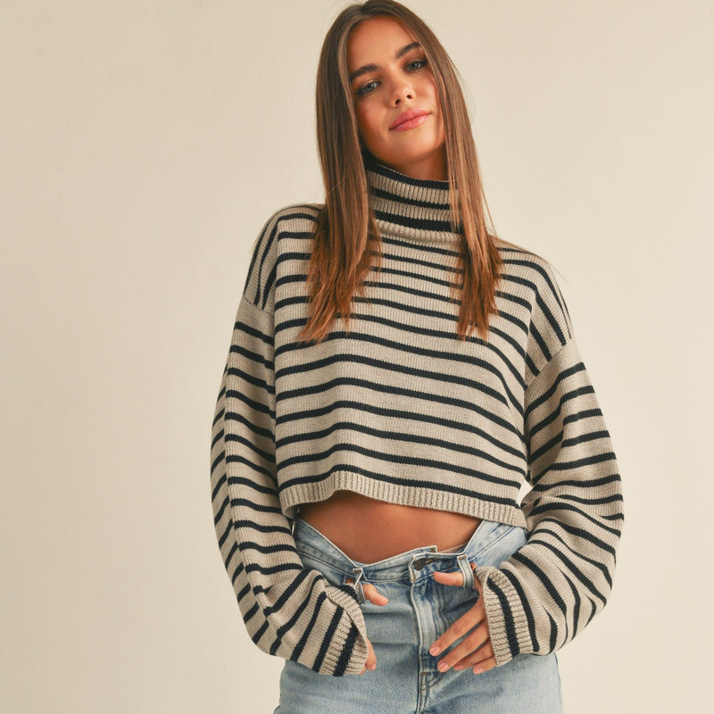 front view of the jenny striped sweater top. shows the cropped length. also shows the turtleneck, the dropped shoulders and the ribbed detailing.