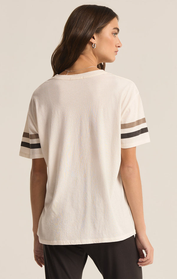 back view of the model wearing the go team boyfriend tee. shows the stripes on the sleeves, and the somewhat oversized fit. 