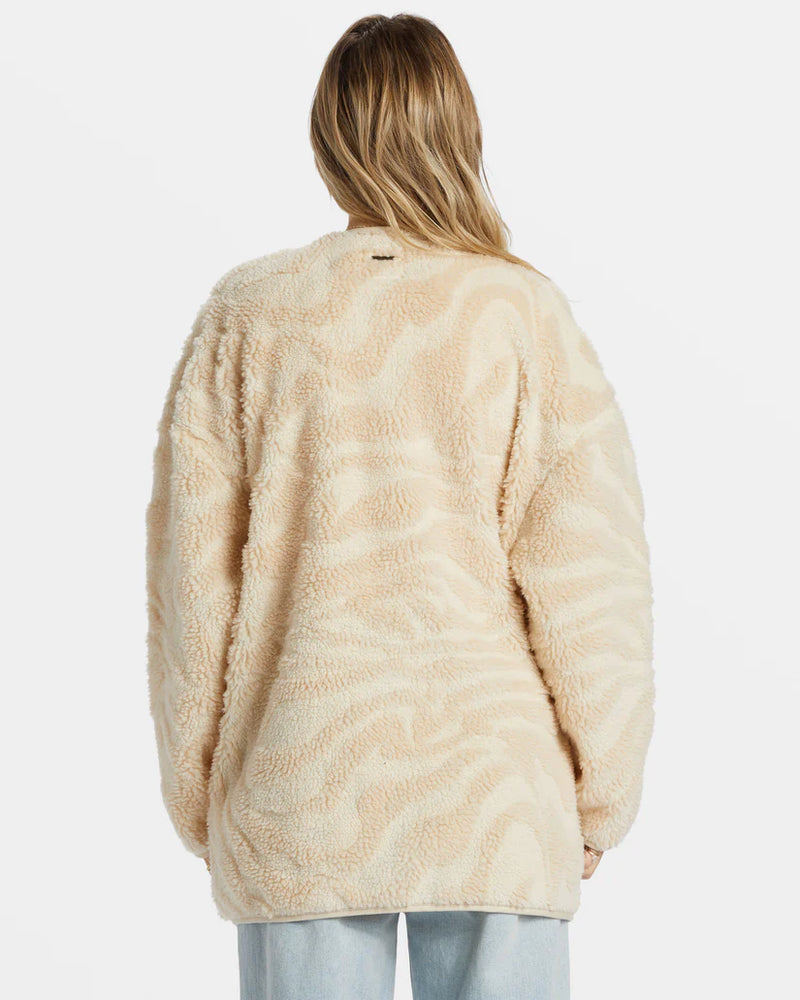 back view of the model wearing the fireside cozy buttoned fleece jacket. shows the oversized fit. also shows the zebra like design and cream color. 