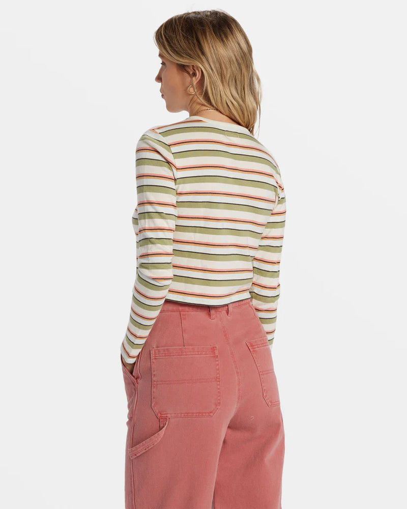 back view of the model wearing the tommy stripe long sleeve top. shows the crew neckline. also shows the stripe pattern, the cropped length and the long sleeves 