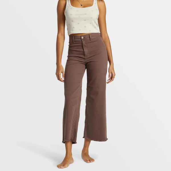 front view of the model wearing the free fall high waist pants. shows the high waist. also shows the button closure, the wide, cropped legs and the beautiful brown color. 