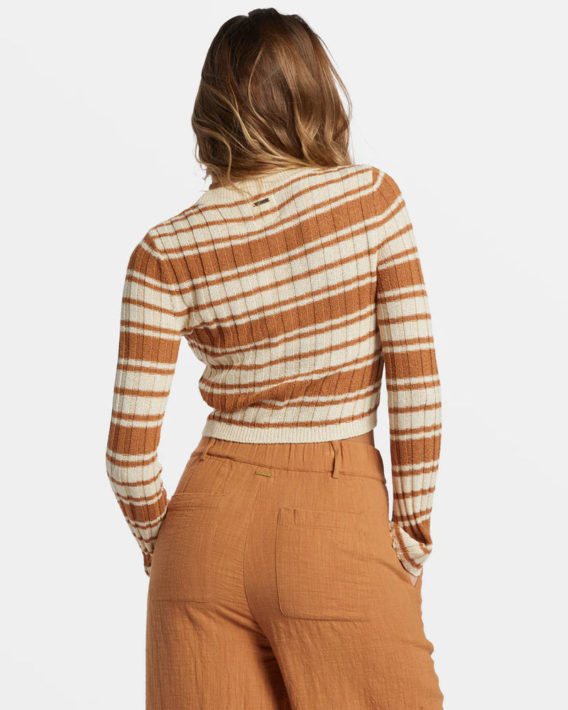 back view of the clare crew neckline. shows the metal plate branding by the neck. also shows the slim fit crop fit, the ribbed detailing on the neckline and the long sleeves. 