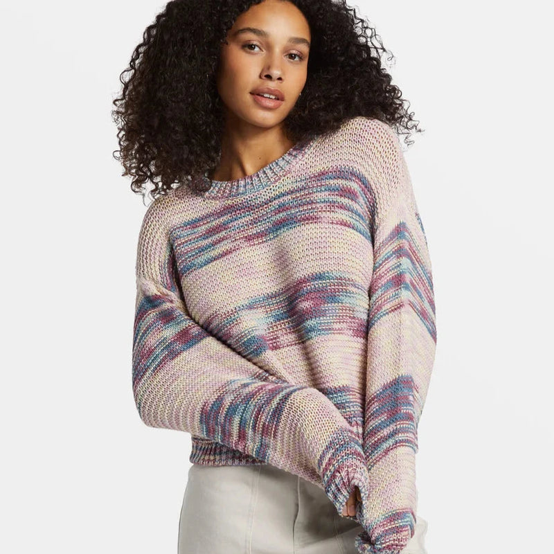 front view of the model wearing the fade out pullover sweater. shows the pullover style. also shows the ribbed detailing on the neckline and sleeves. also shows the scoop neckline and the multicolored striping throughout. 