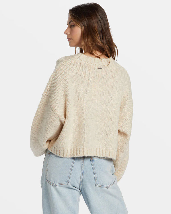 back view of the model wearing the modern love pullover sweater. shows the dropped shoulders. also shows the scoop neckline, the ribbed hems and the relaxed fit. 