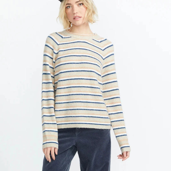 front view of the model wearing the girl guide sweater. shows the crew neckline. also shows the relaxed, slouchy fit, the raglan sleeves and the stripe pattern. 