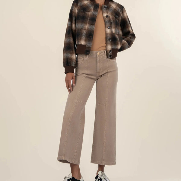 front view of the model wearing the enley yoke bomber jacket. shows the front patch pockets. also shows the plaid print, the button down closure. 