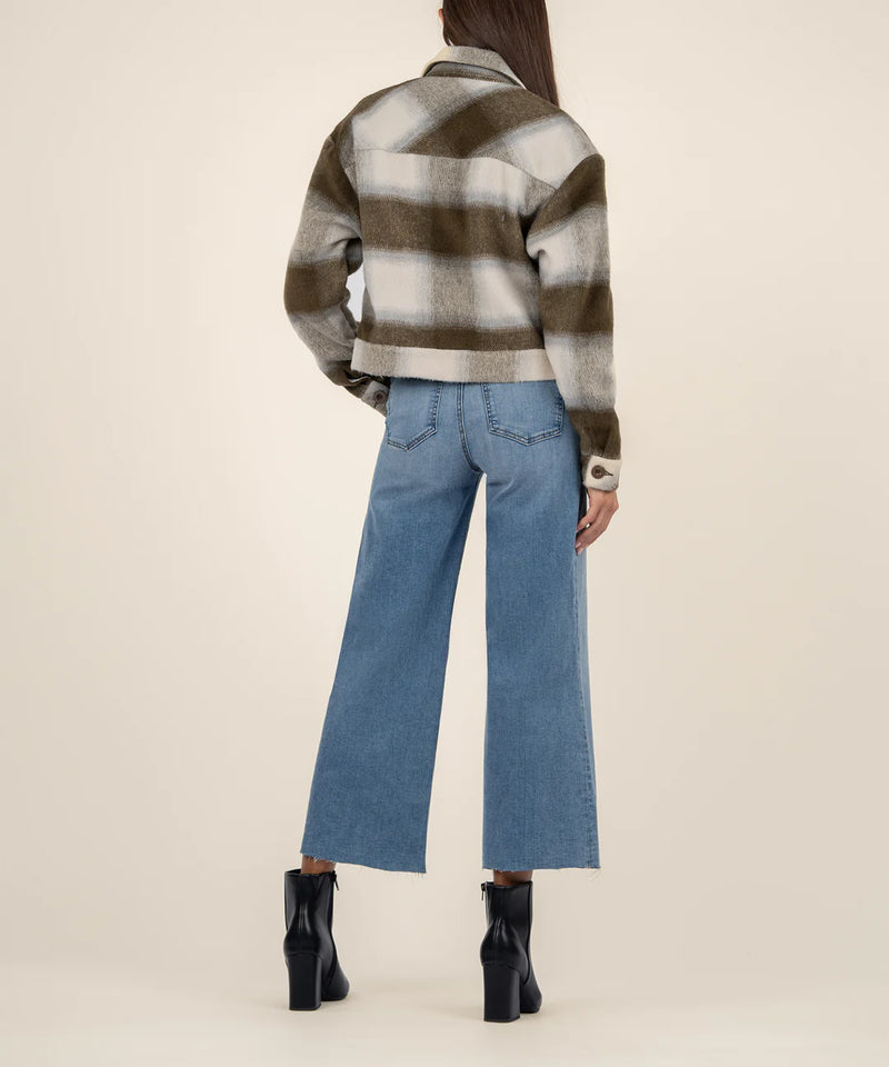 back view of the model wearing the luciana crop jacket. shows the collar. also shows the dropped shoulders, the button closure on the cuffs, the cropped length, and the plaid pattern. 