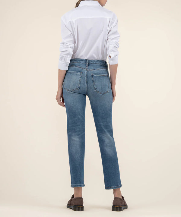 back view of the model wearing the elizabeth high rise straight leg jeans. shows the back pockets. also shows the straight leg, the medium wash and the slight cropped. 