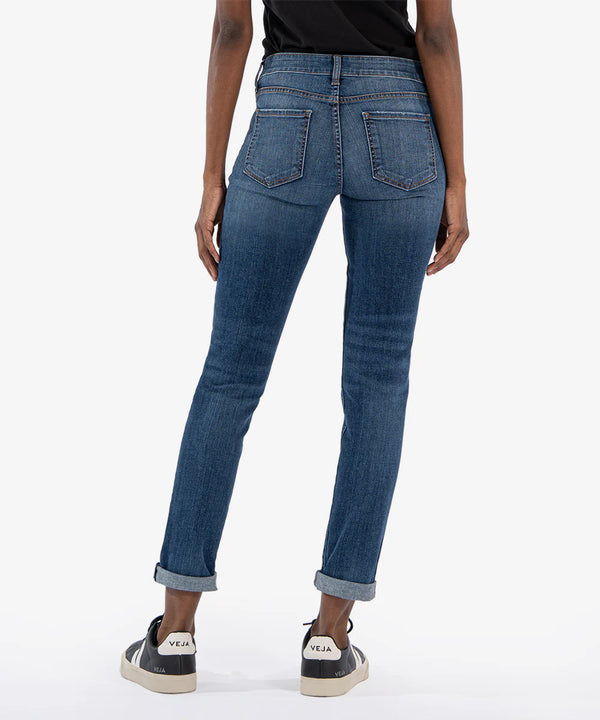 back view of the model wearing the catherine mid rise boyfriend jeans. shows the back pockets. also shows the bottom rolled cuffs, and the mid rise. 