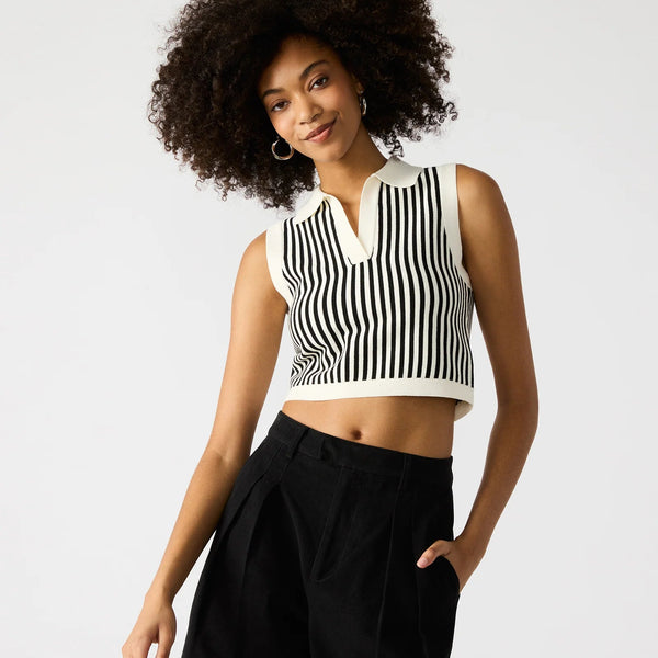 front view of the model wearing the amery sweater top. shows the black & white stripes. also shows the collared neckline, that the top is sleeveless and that it is cropped. 