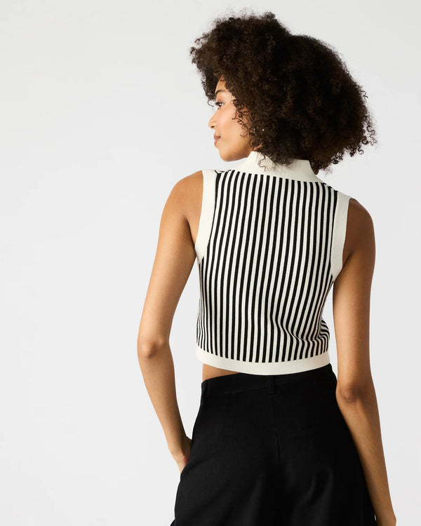 back view of the model wearing the amery sweater top. shows that the top is sleeveless. also shows the cropped length of the shirt, the collared neckline and the black & white stripes. 