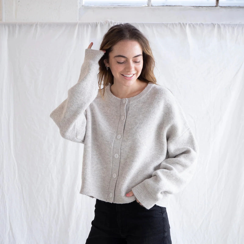 front view of the alyssa cardigan in heather oat. shows the scoop neckline. also shows the oversized buttons, button down closure and the oversized sleeves. 