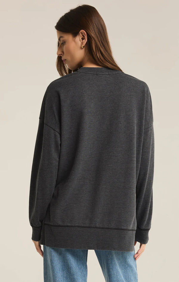 back view of the model wearing the modern v neck weekender. shows the dropped shoulders. also shows the seam detailing and also shows that the back is little longer than the front. 