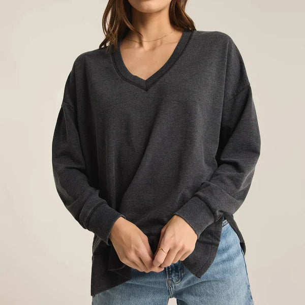 front view of the model wearing the modern v neck weekender. shows the v neckline. also shows the side slits and the dropped shoulders. 