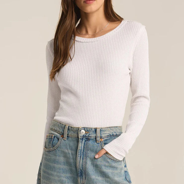 front view of the model wearing the arlet thermal top. shows the crew neckline. also shows the raw hems, the waffle knit texture and the classic fit. 