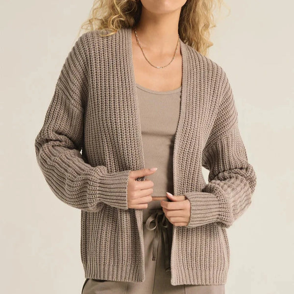 front view of the sutton rib cardigan. shows the open front. also shows the dropped shoulders, the ribbed detailing and the tighter cuffs. 