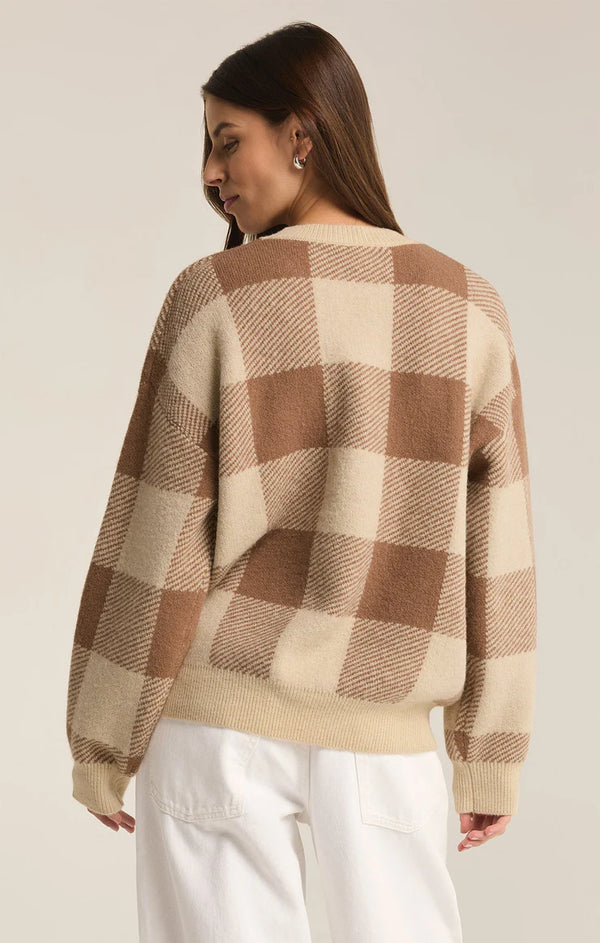 back view of the model wearing the check you later sweater. shows the dropped shoulders. also shows the check print throughout, and the regular fit. 