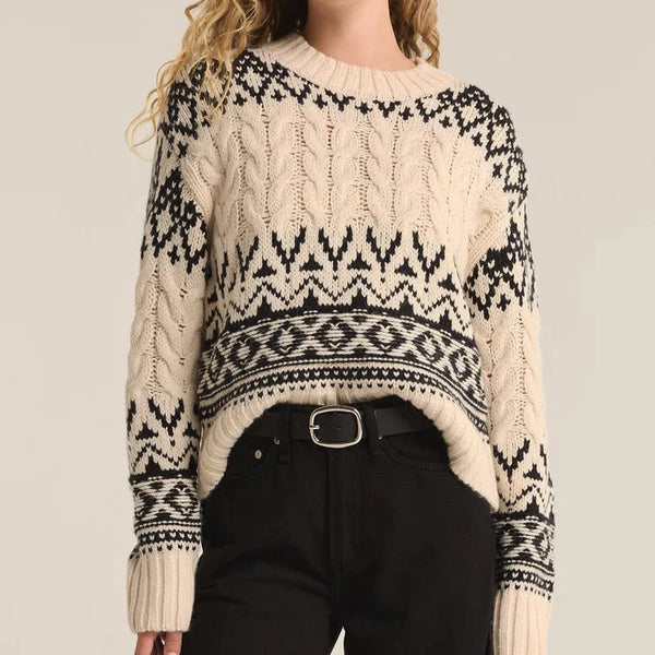 front view of the model wearing the garland fairisle sweater. shows the fun pattern. also show crew neckline, the regular fit and the cable knit detailing. 