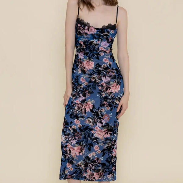 front view of the model wearing the vanessa velvet floral mesh midi dress. shows the all over floral print. also shows the spaghetti straps, the lace peak detailing and the cowl neckline. 