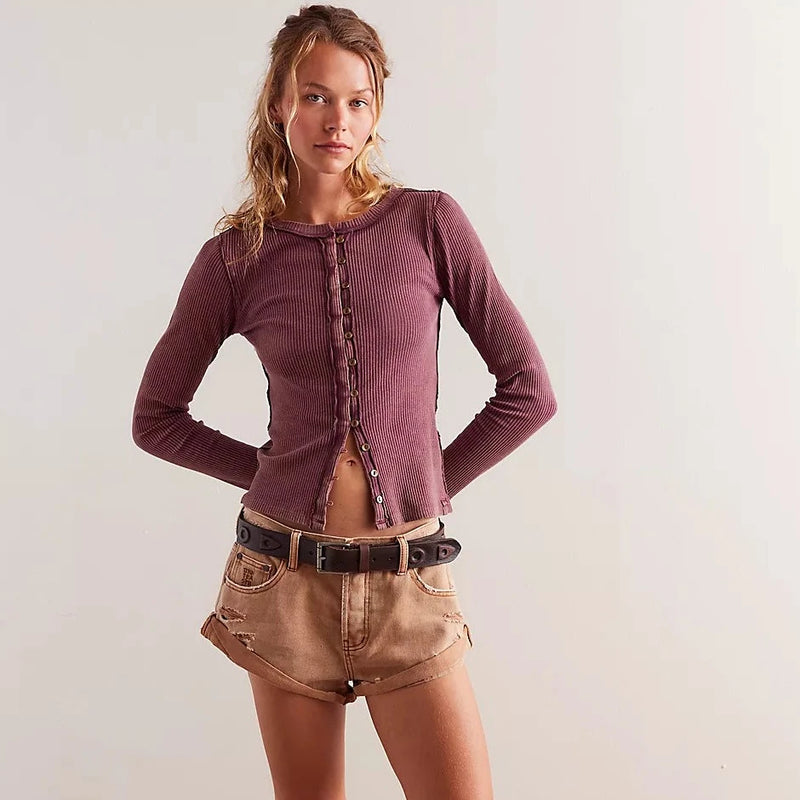 front view of the model wearing the its on cardi. shows the tight fitting sleeves. also shows the slim, relaxed fit, the front button down closure and the exposed seams. 