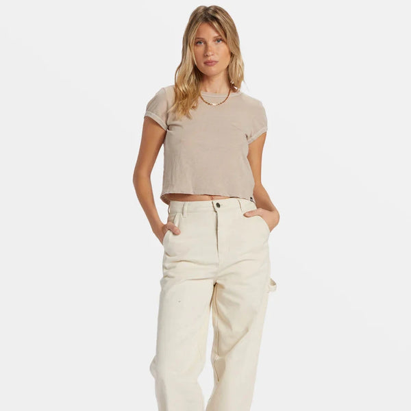 front view of the model wearing the daily tee. shows the crew neckline. also shows the ribbed detailing on the sleeves and neckline, shows the fitted style and the cropped length. 