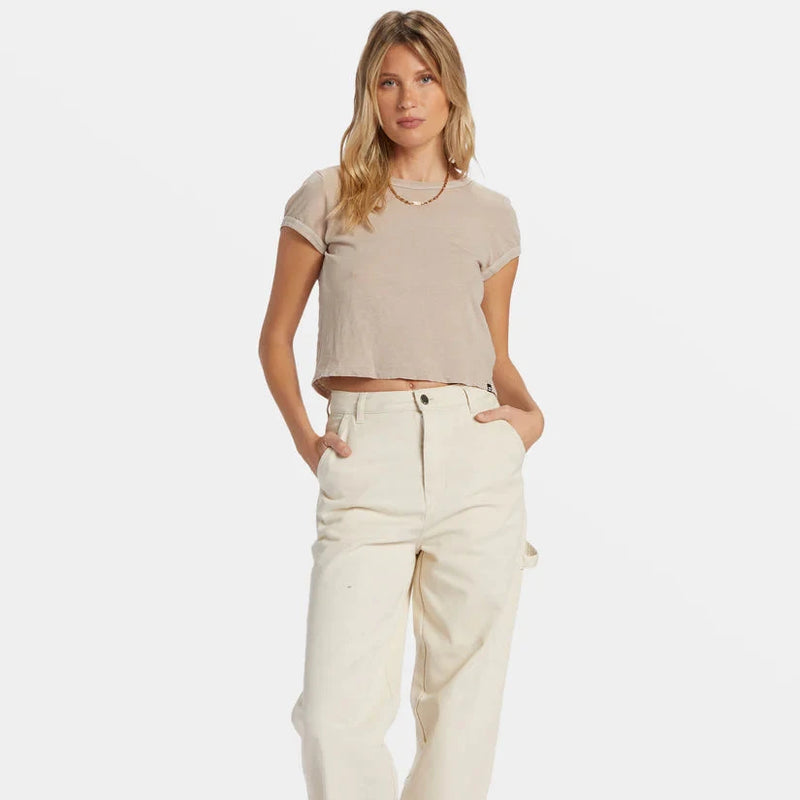 front view of the model wearing the daily tee. shows the crew neckline. also shows the ribbed detailing on the sleeves and neckline, shows the fitted style and the cropped length. 