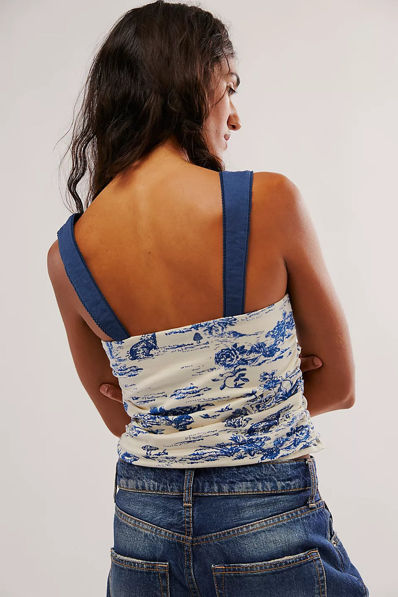 back view of the model wearing the 2 tone printed tank. shows the straight across back. also shows the straps are a solid blue and the body part of the tank is printed. 