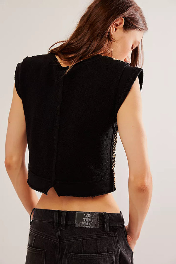 back view of the lola top. shows the cropped length. also shows the sleeveless silhouette, the exposed seams and the little upside v cutout at the bottom.  
