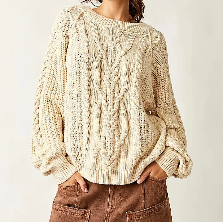 front view of the frankie cable sweater. shows the color ivory. also shows the scoop neckline, the slouchy, relaxed fit and the ribbed hems. 