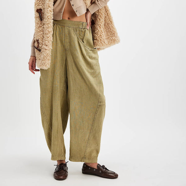 front view of the model wearing the high road pull on barrel pants. shows the mid rise. also shows the pull on style, the front pockets and the green color of the pants. 