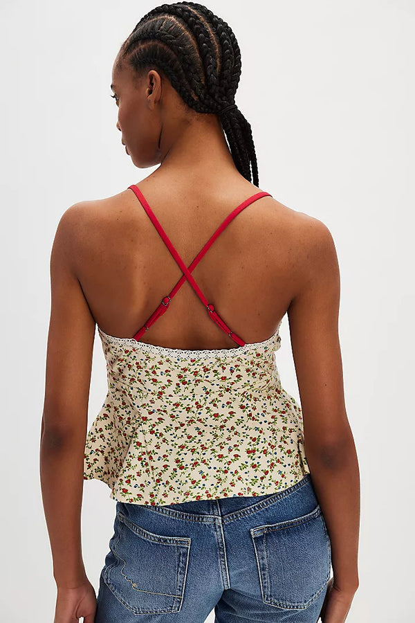 back view of the model wearing the sammi tank. shows the adjustable straps. also shows the lace trim, the floral print and the peplum style body of the tank.  