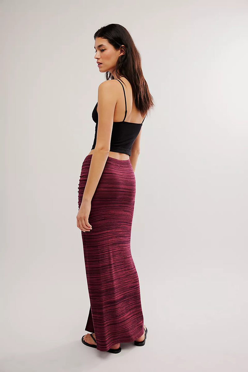 back view of the model wearing the peak show maxi skirt. shows the maxi length. also shows the pull on style and the side slit. 