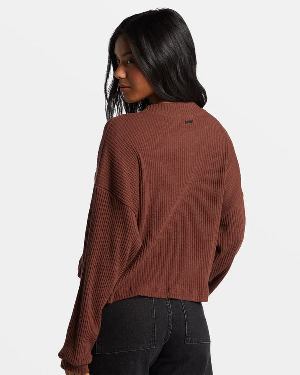 back view of the model wearing the good catch henley. shows the dropped shoulders. also shows the ribbed detailing throughout, the crew neckline and the branding metal plate by neckline. 