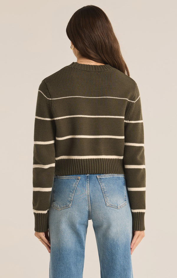 back view of the model wearing the milan stripe sweater, shows the ribbed detailing. also shows the slim fit and the crew neckline. 