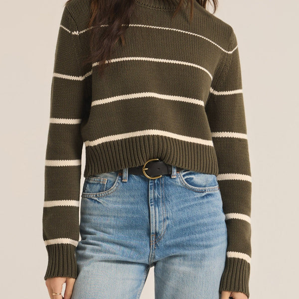 front view of the model wearing the milan stripe sweater. shows the slim fit. also shows the ribbed detailing, the stripe design and the crew neckline. 