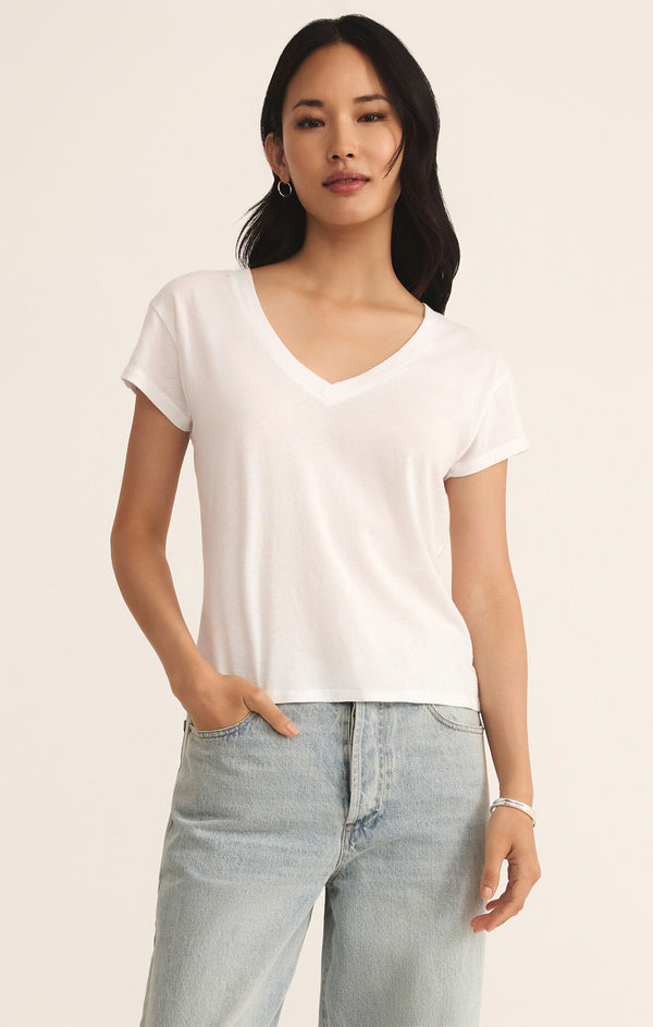 front view of the model wearing the modern v neck tee. shows the v neckline. also shows the short sleeve, the regular and the white color. 