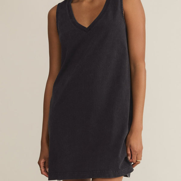 front view of the model wearing the sloane v neck mini dress. shows the black color. also shows the v neckline, the relaxed fit and that it is sleeveless. 