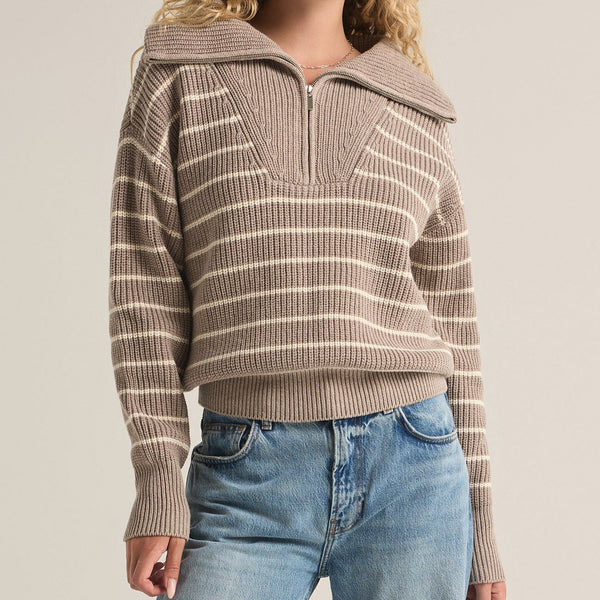 front view of the model wearing the villa half zip sweater. shows the dropped shoulders. also shows the quarter zip, ribbed detailing and tighter bottom band.  