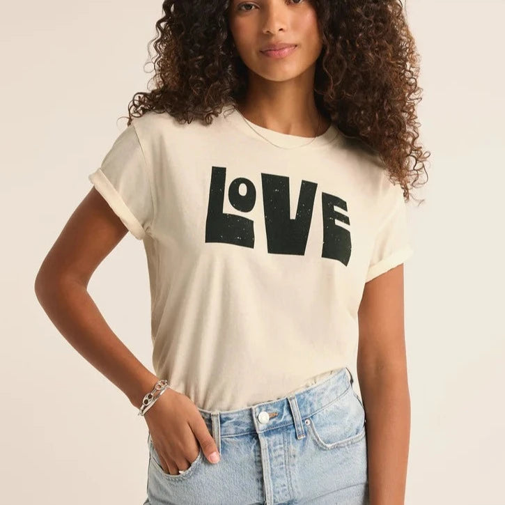 front view of the model wearing the love you boyfriend tee. shows the LOVE graphic on the front. also shows the crew neckline, the relaxed fit and the short sleeves. 