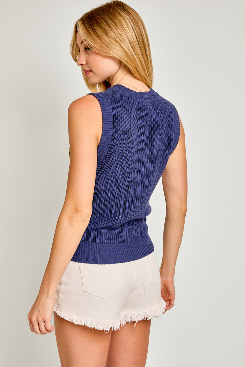 back view of the model wearing the michigan sleeveless sweater top. shows the sweater knit fabric. also shows that the top is sleeveless and the ribbed detailing. 