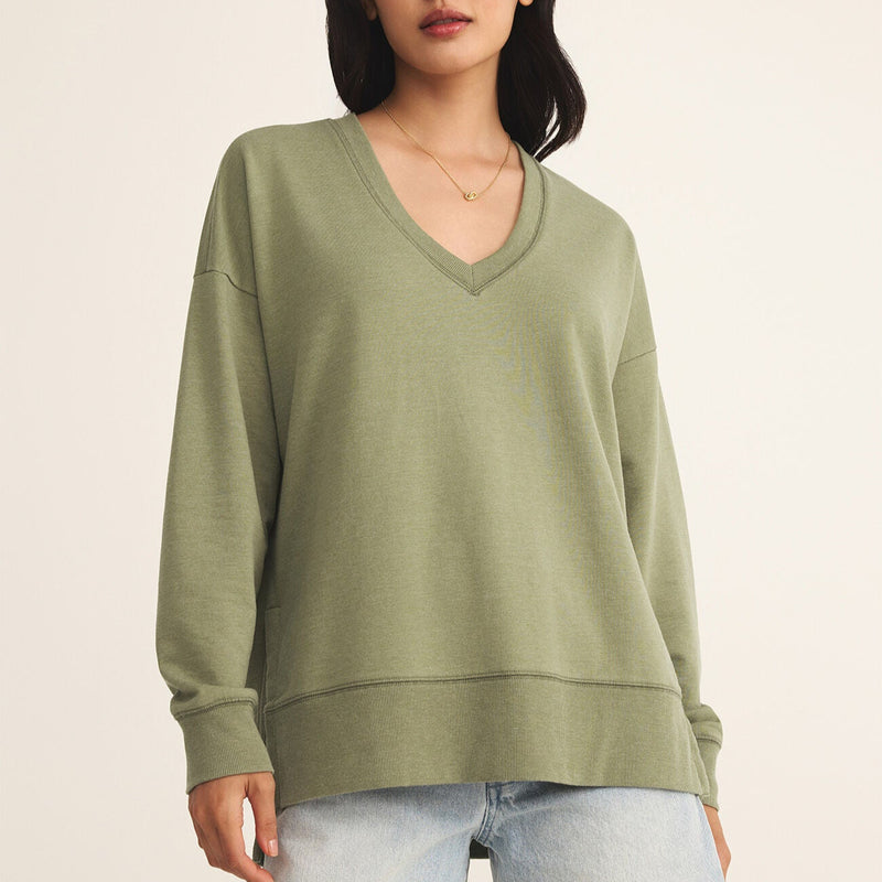 front view of the model wearing the modern v neck weekender. shows the green color. also shows the v neckline, the detailed seaming and the oversized fit. 