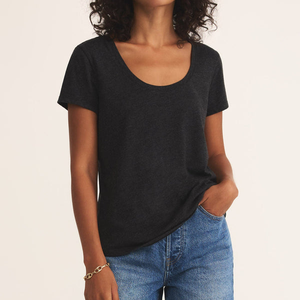 front view of the model wearing the anywhere scoop tee. shows the scoop neckline. also shows the relaxed fit, the black color and the short sleeves. 