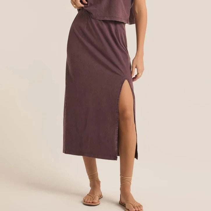 front view of the model wearing the shilo knit skirt. shows the front slit. also shows the midi length, the high waist and the mineral wash. 