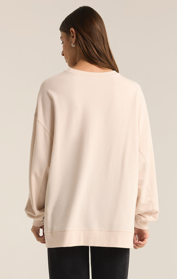 back view of the model wearing the modern weekender. shows the dropped shoulders. also shows the relaxed fit, and the back is little longer then the front. 