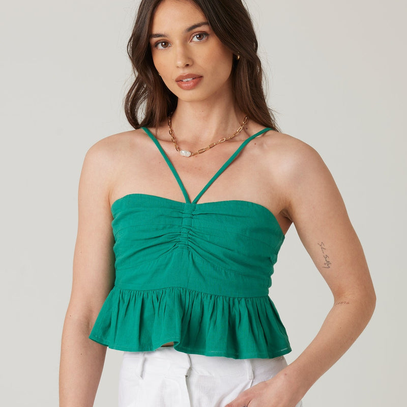 front view of the model wearing the seaview top. shows the synched detail in the front. also shows the ruffle bottom detail, the straps the start in the middle and go over the shoulders. 