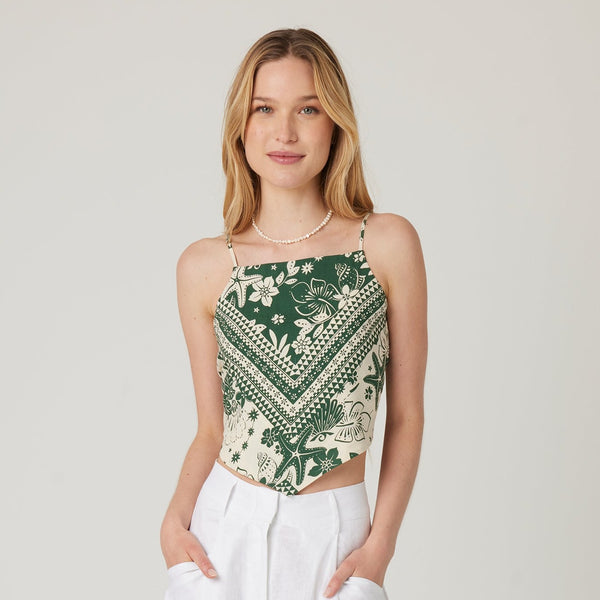 front view of the model wearing the ellis top. shows the high square neckline. also shows the handkerchief style, that the top is somewhat cropped and the top is sleeveless.  