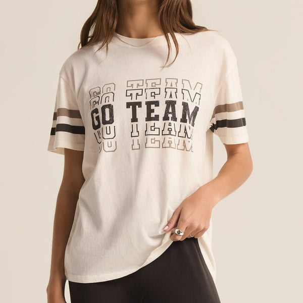 front view of the model wearing the go team boyfriend tee. shows the the go team wording on the front. also shows the stripes on the sleeves, the crew neckline and the some what oversized fit. 