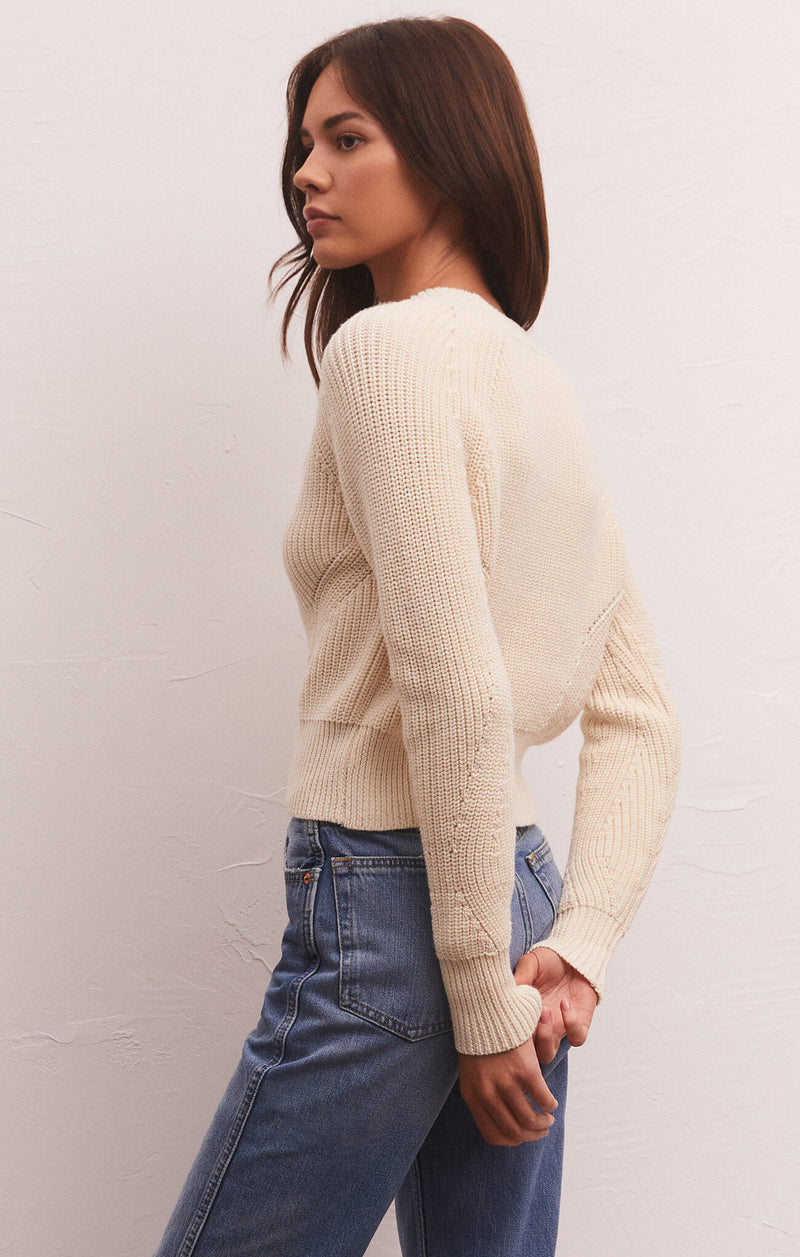 back view of model in cardigan. shows the knitted fabrication and cropped length.