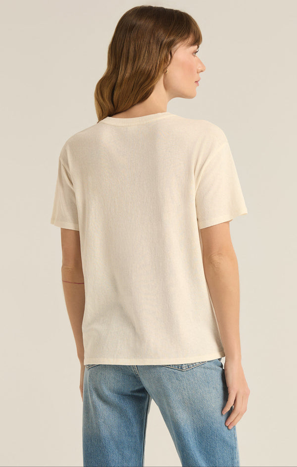 back view of the model wearing the wine & cheese pacific tee. shows the crew neckline. also shows the short sleeves and the relaxed fit. 