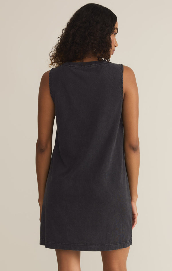 back view of the model wearing the sloane v neck mini dress. shows the relaxed fit. also shows the black color, the sleeveless. 